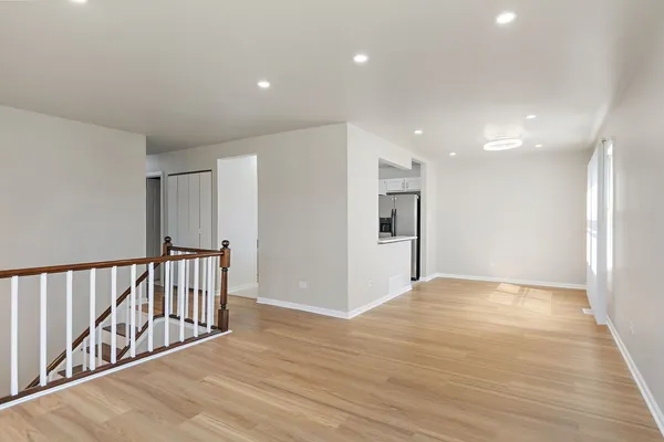 a view of an empty room with wooden floor