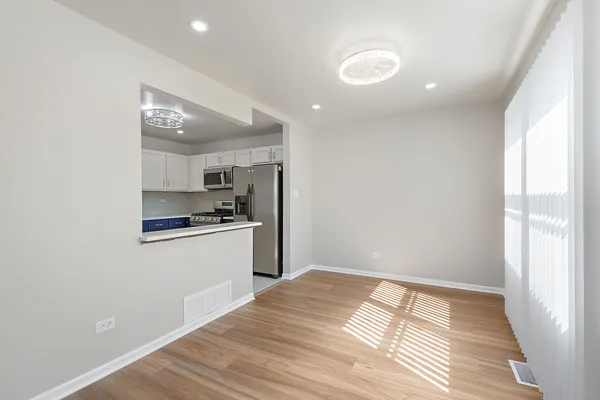a kitchen with a refrigerator and microwave