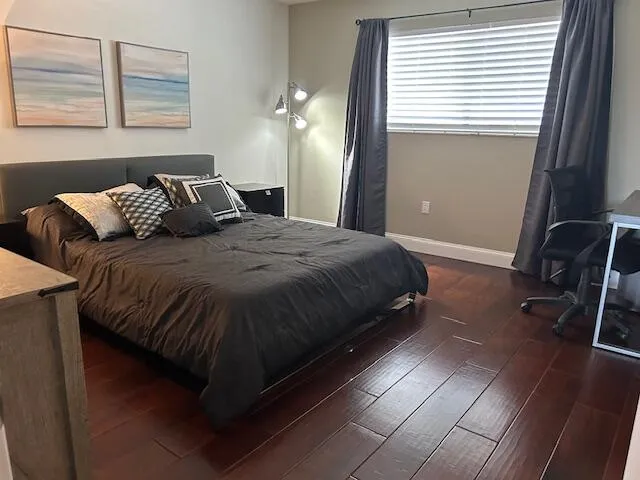 a bedroom with a bed and a window