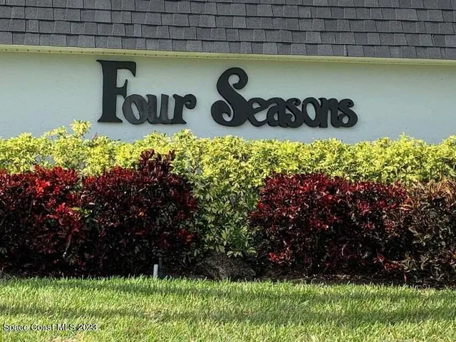 a kitchen with stainless steel appliances a sink a stove a microwave a refrigerator a counter top space and cabinets