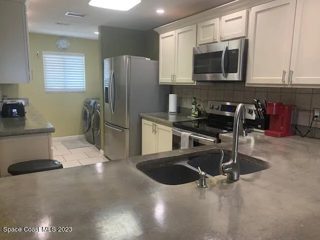 a kitchen with stainless steel appliances granite countertop a sink and cabinets