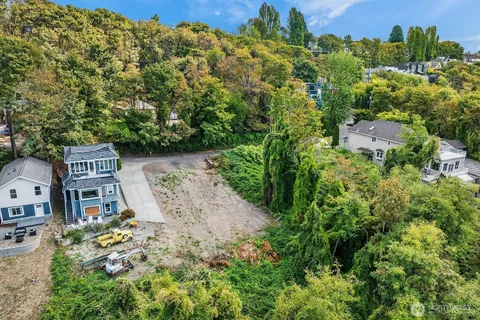 an aerial view of a house with a yard