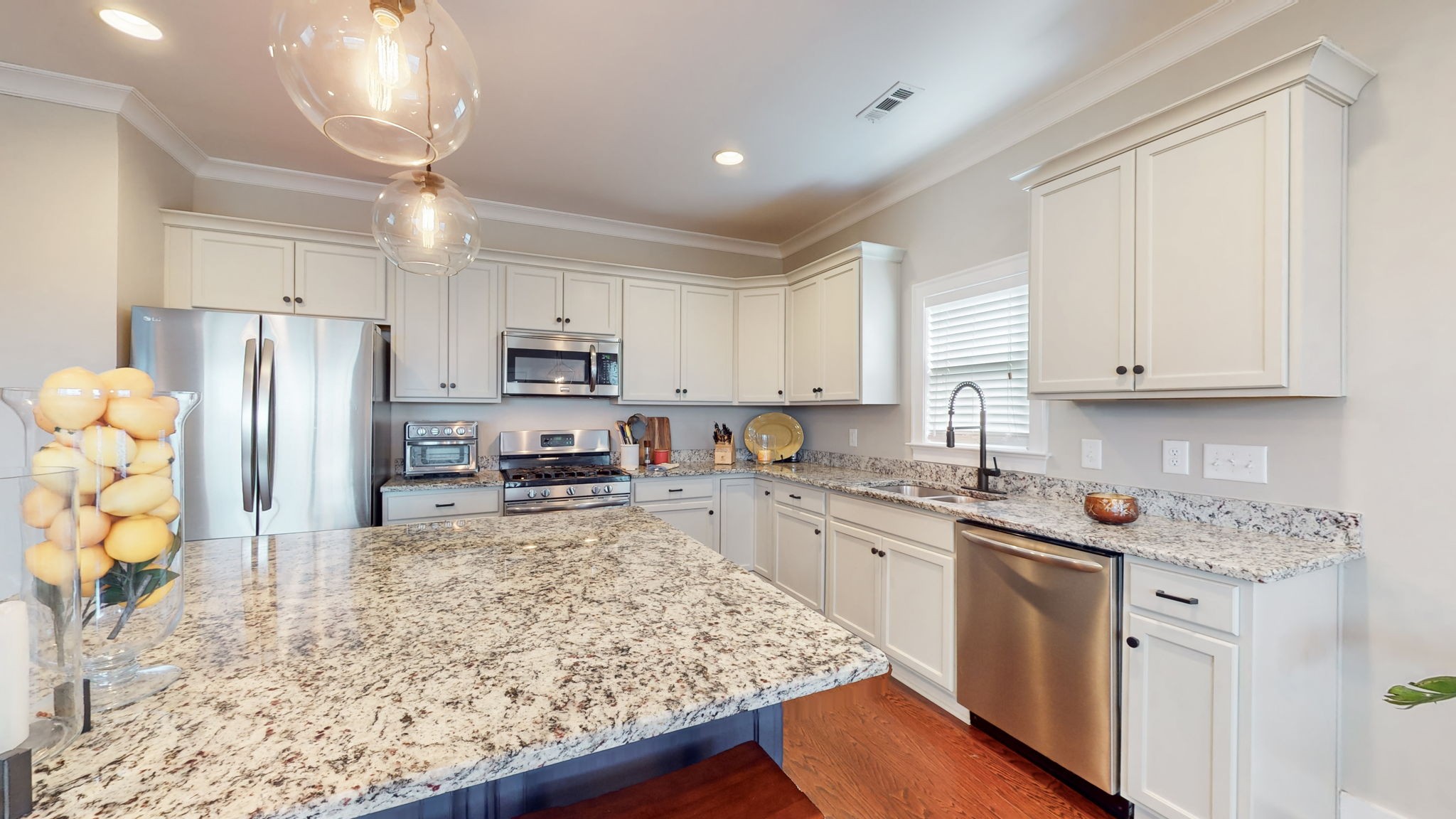 4031 Ryecroft Lane Franklin, TN 37064 - Photo 12 of 51 a kitchen with stainless steel appliances granite countertop a stove top oven a refrigerator a sink and dishwasher with wooden floor