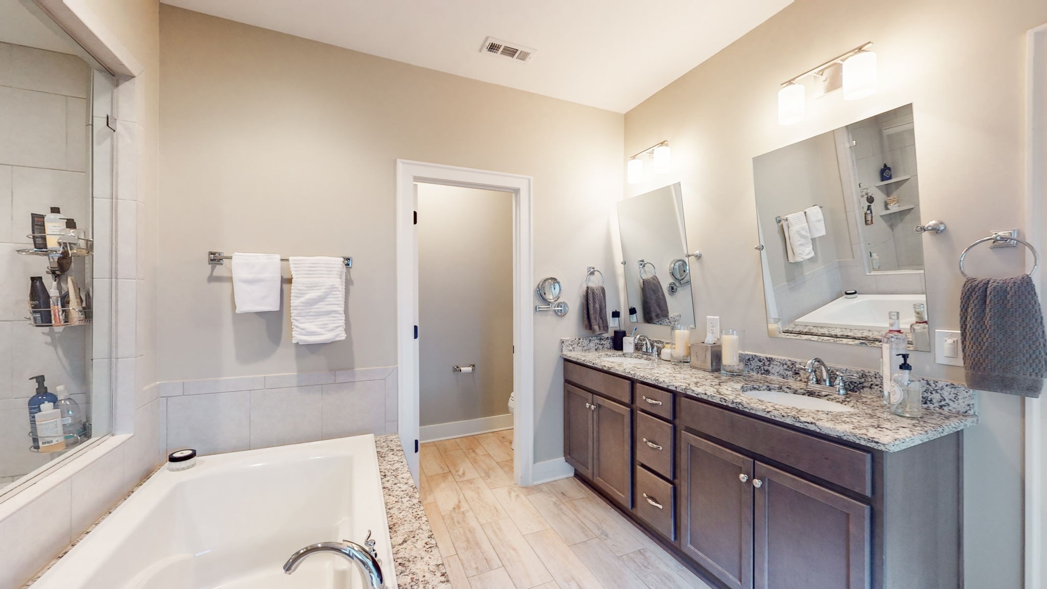 4031 Ryecroft Lane Franklin, TN 37064 - Photo 23 of 51 a spacious bathroom with a tub sink shower and mirror