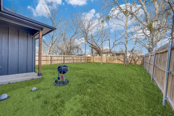 a green field with some trees in the background