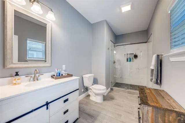 a bathroom with a sink toilet and shower