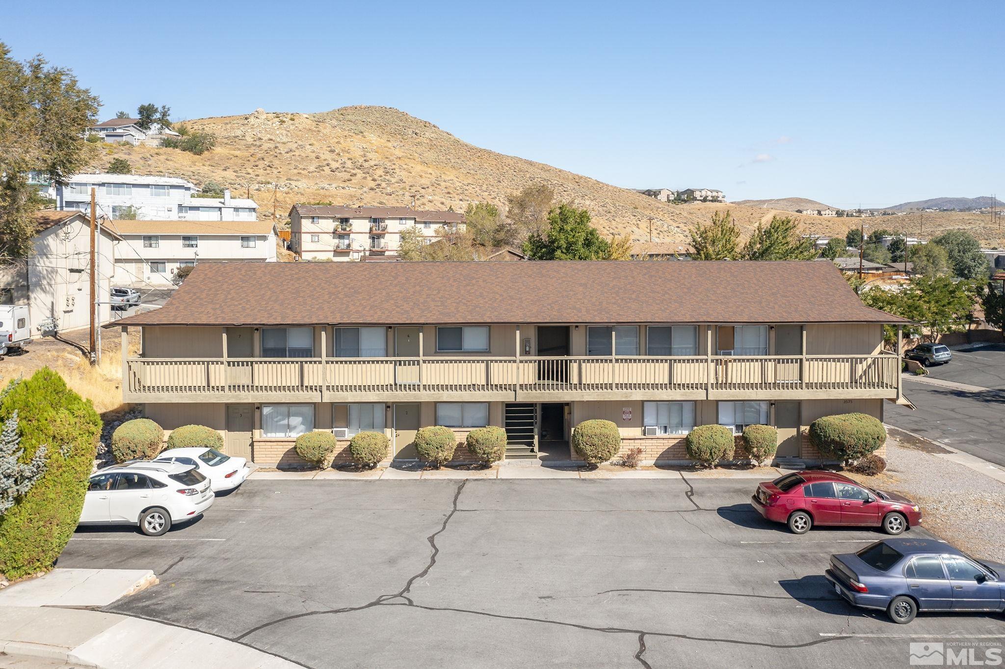 a front view of a house with a garden and parking space