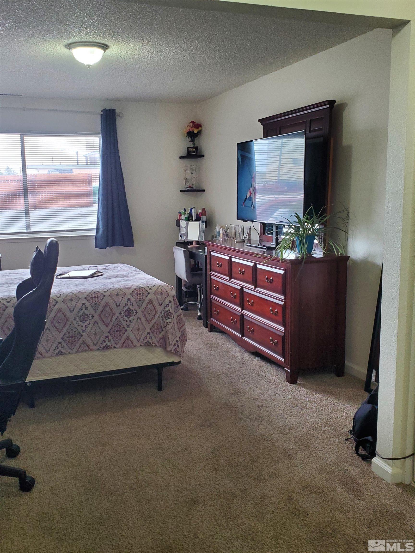 3575 Gypsum Road Reno, NV 89503 - Photo 14 of 32 a bedroom with furniture and a window