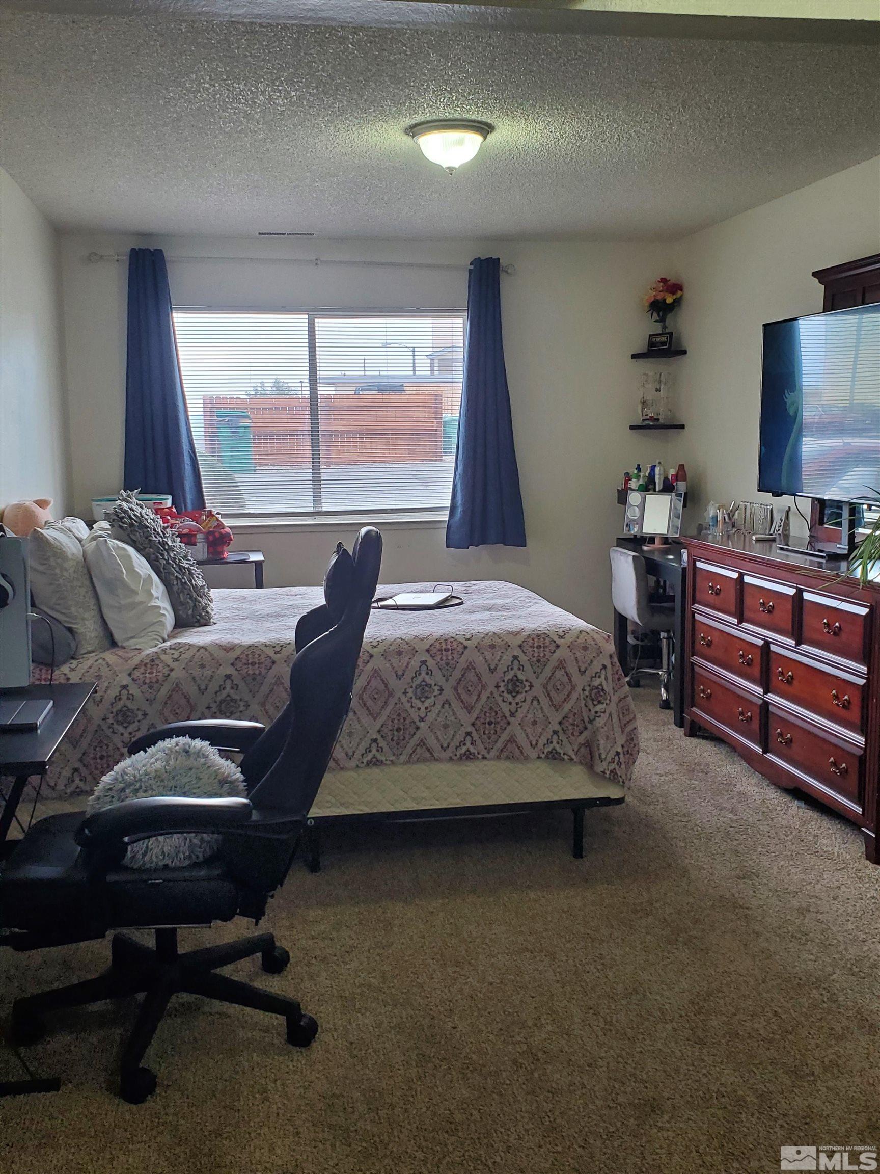3575 Gypsum Road Reno, NV 89503 - Photo 17 of 32 a bedroom with a bed and a window