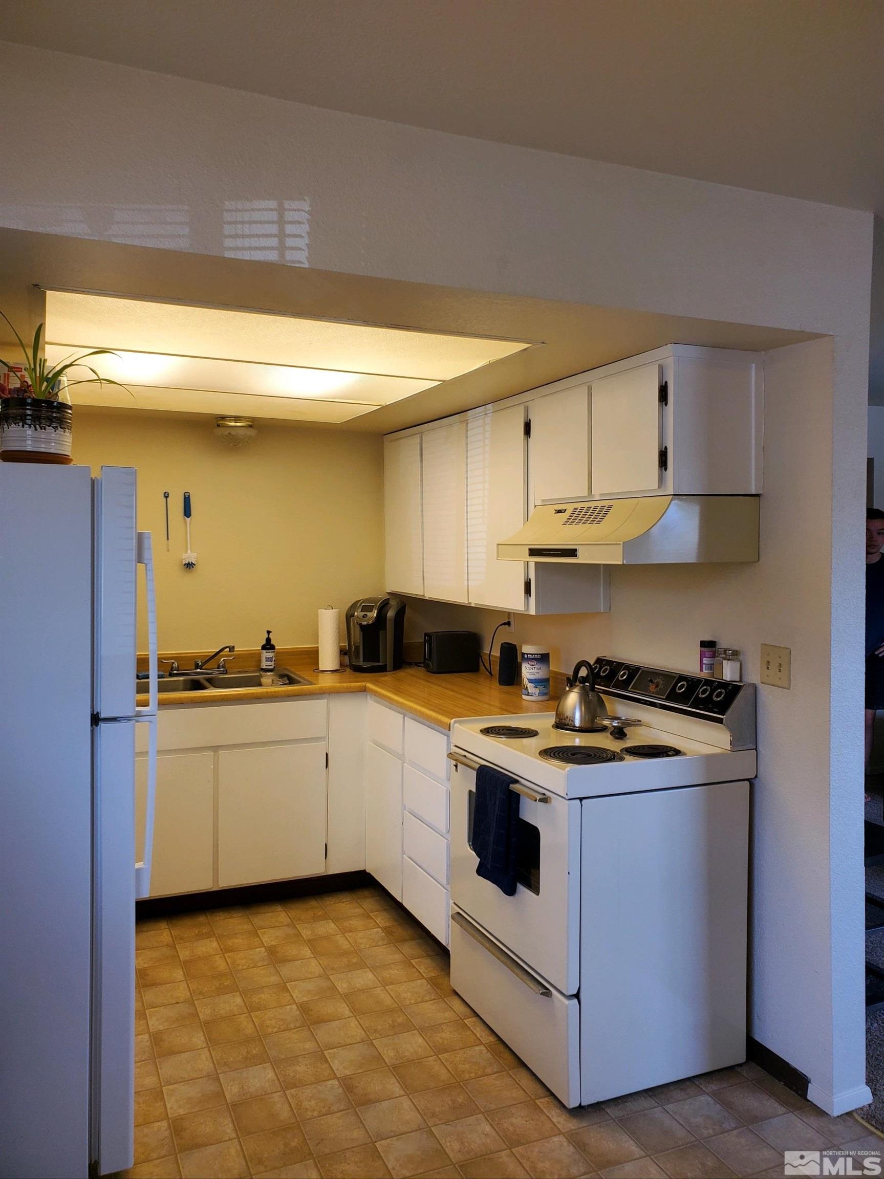 3575 Gypsum Road Reno, NV 89503 - Photo 29 of 32 a kitchen with a stove top oven sink and cabinets