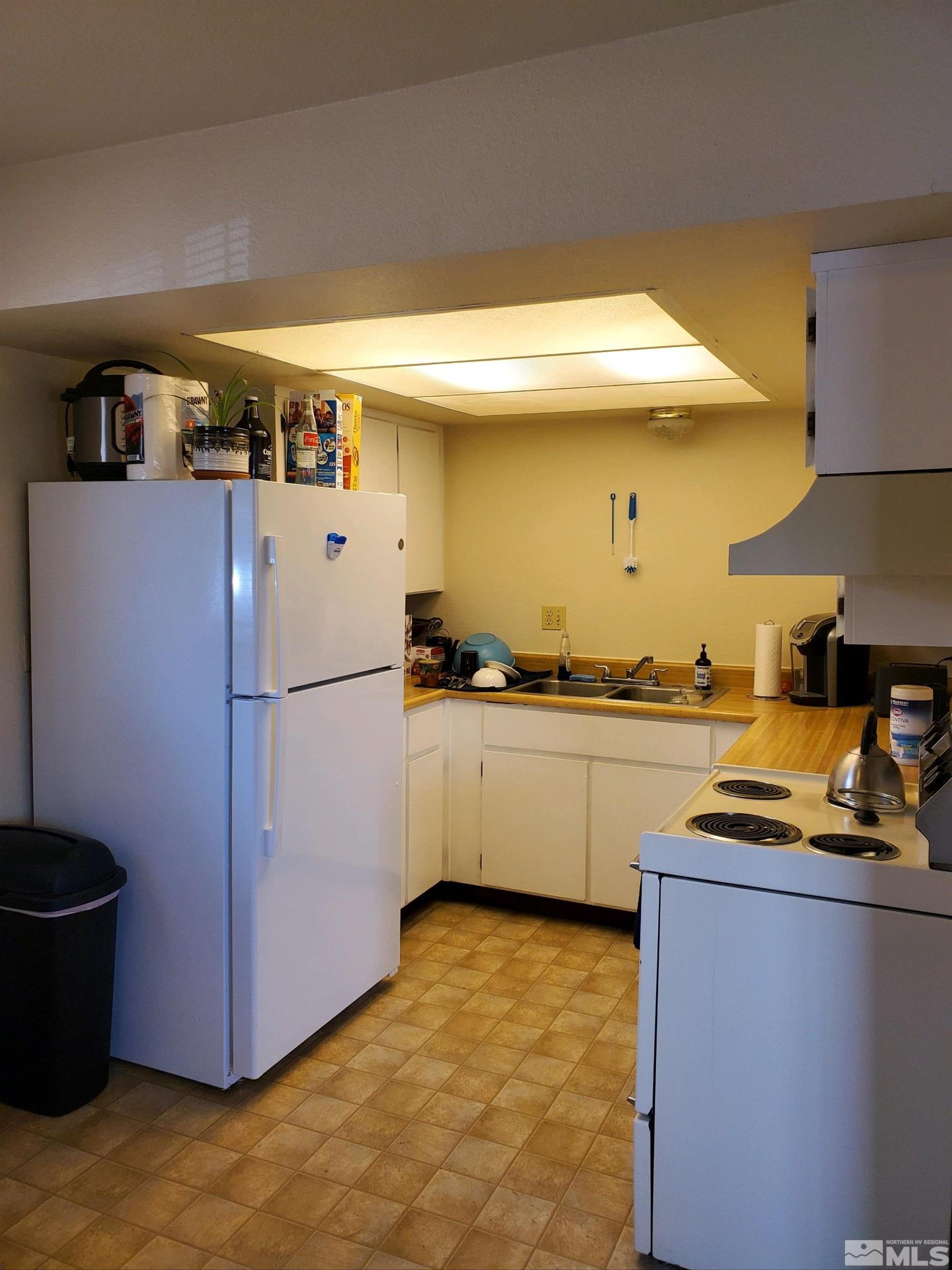 3575 Gypsum Road Reno, NV 89503 - Photo 30 of 32 a kitchen with a refrigerator and a stove