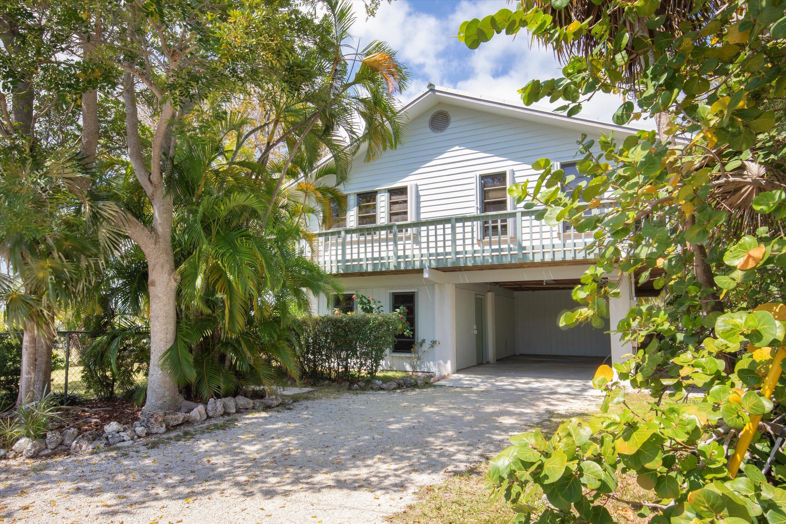 3714 Pine Street Big Pine Key, FL 33043 - Photo 1 of 64 a view of a house with a yard and potted plants