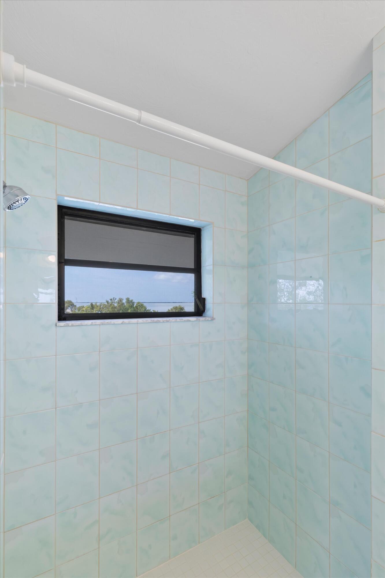 3714 Pine Street Big Pine Key, FL 33043 - Photo 26 of 64 a bathroom with a shower and a window