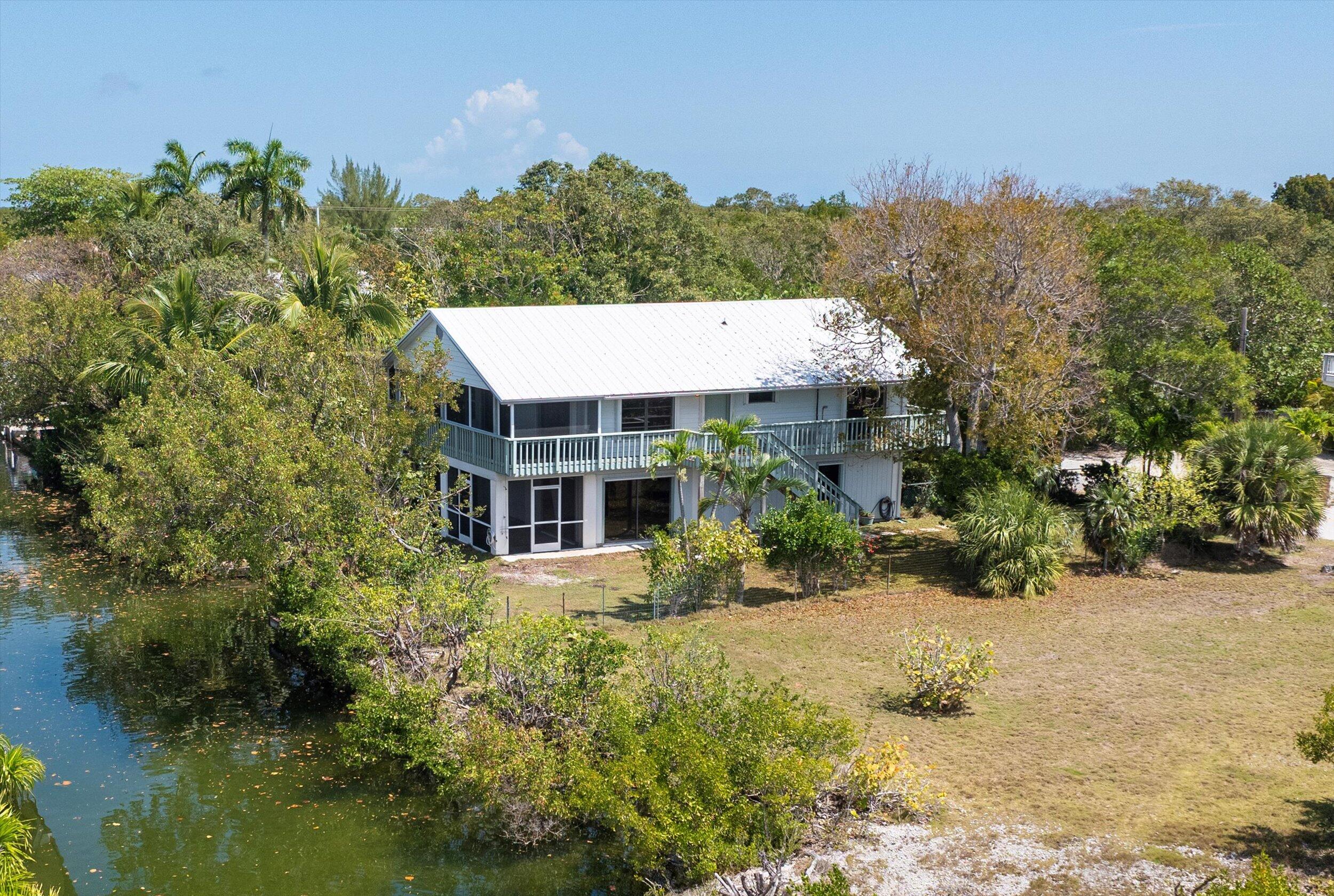 3714 Pine Street Big Pine Key, FL 33043 - Photo 30 of 64 an aerial view of a house with a yard and large trees