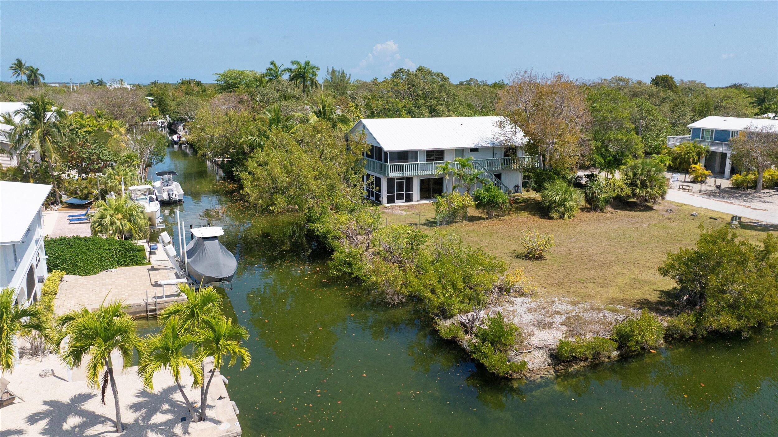 3714 Pine Street Big Pine Key, FL 33043 - Photo 3 of 64 an aerial view of a house with swimming pool and lake view