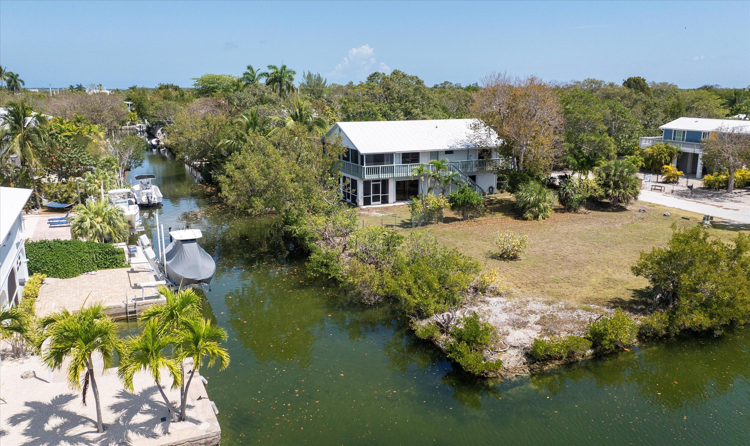 3714 Pine Street Big Pine Key, FL 33043 - Photo 31 of 64 a view of a lake with a house in the background