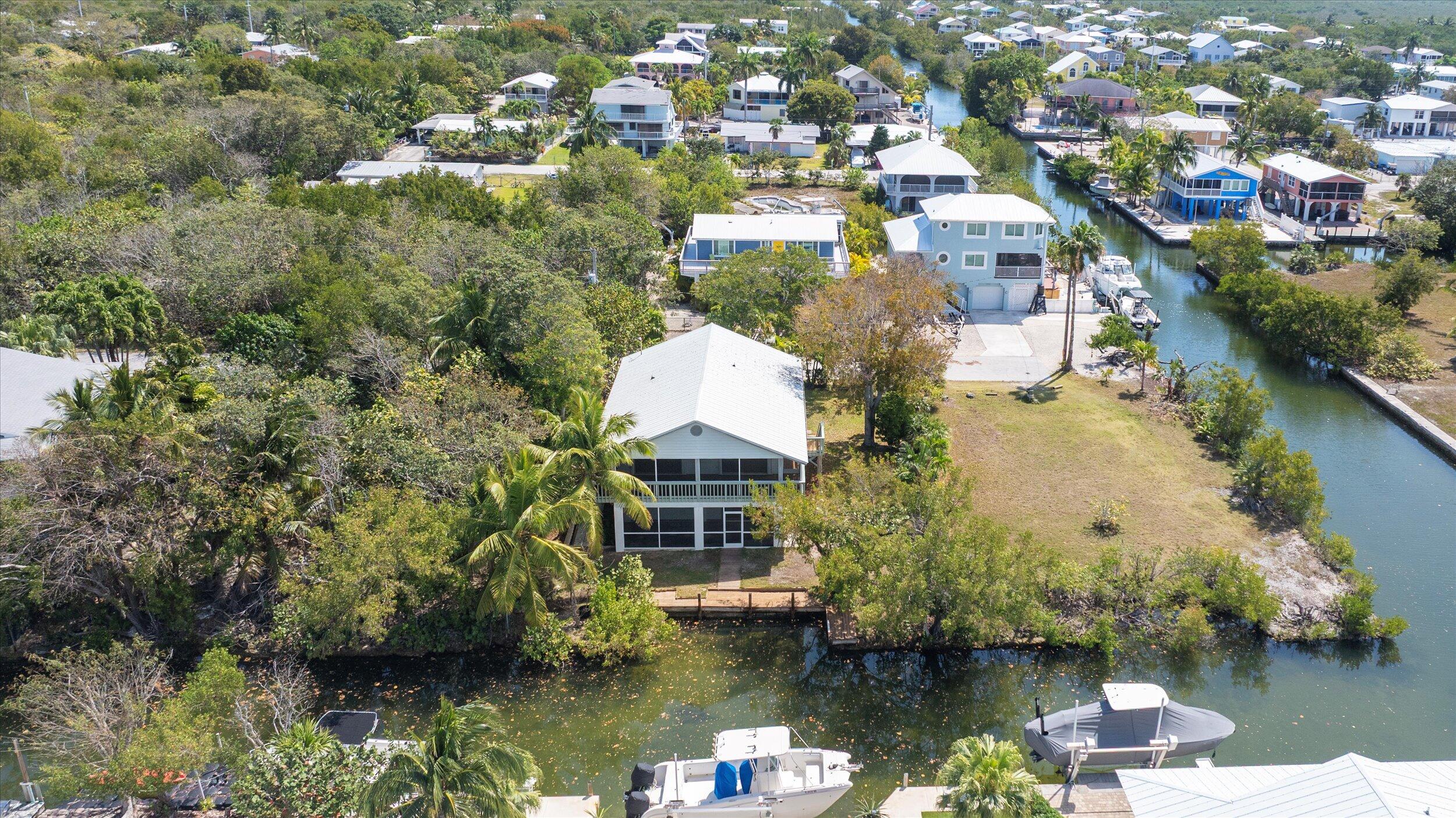 3714 Pine Street Big Pine Key, FL 33043 - Photo 49 of 64 an aerial view of a house with a yard lake and trees all around