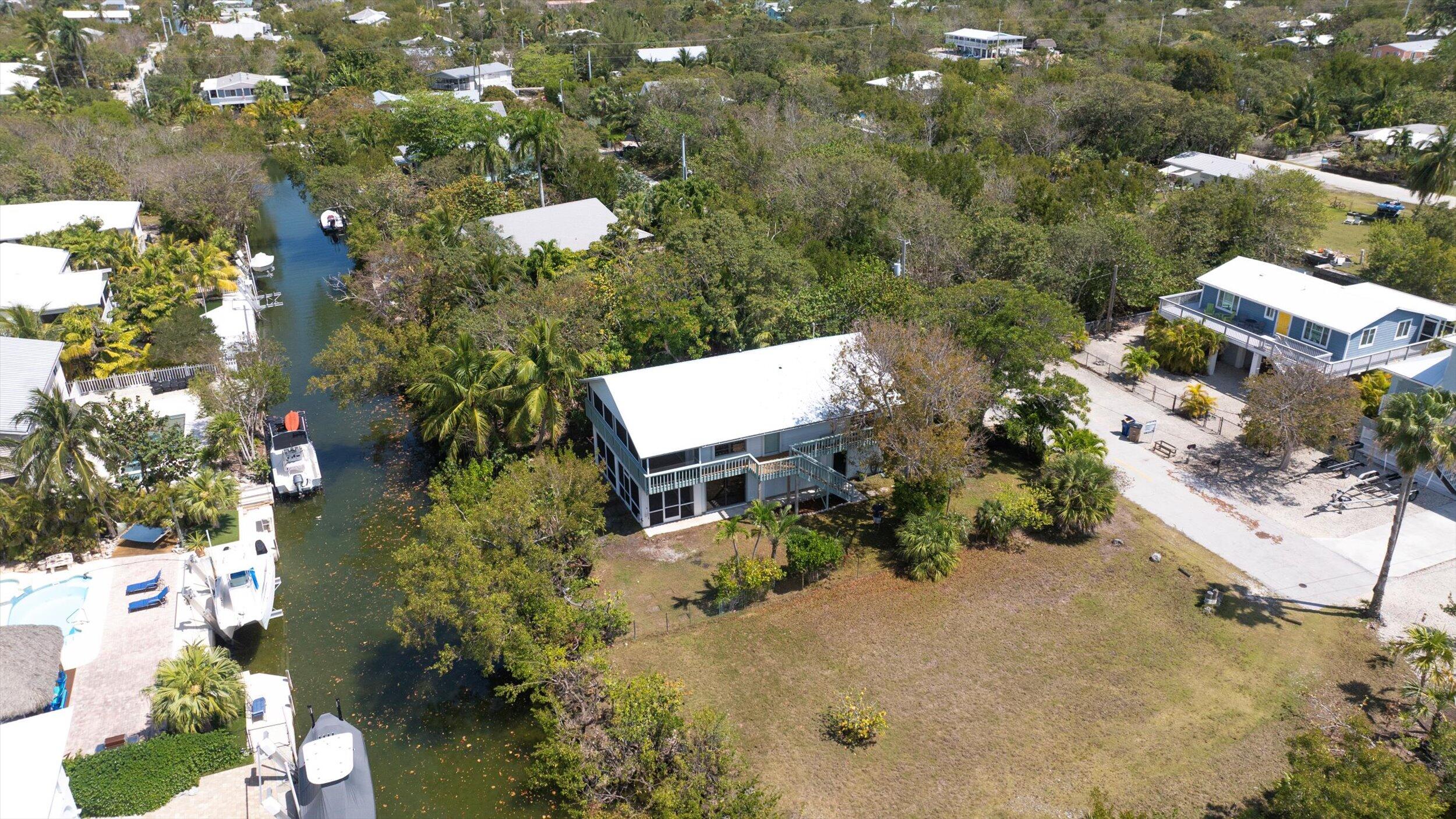3714 Pine Street Big Pine Key, FL 33043 - Photo 56 of 64 an aerial view of a house with a yard and lake view
