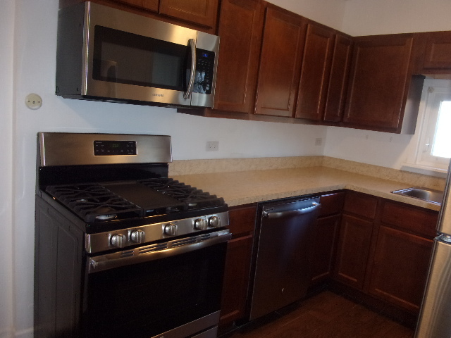 2918 Ridge Road Lansing, IL 60438 - Photo 3 of 7 a kitchen with a stove microwave and sink