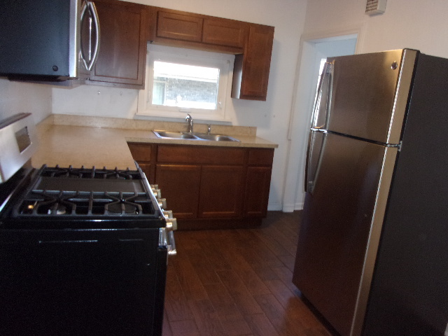 2918 Ridge Road Lansing, IL 60438 - Photo 4 of 7 a kitchen with a refrigerator and a sink