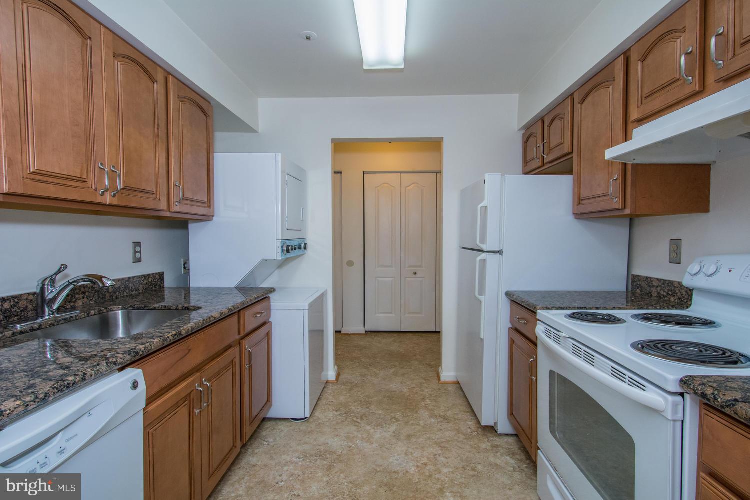 8335 Montgomery Run Road, Unit H Ellicott City, MD 21043 - Photo 2 of 22 a kitchen with stainless steel appliances granite countertop a sink stove and refrigerator