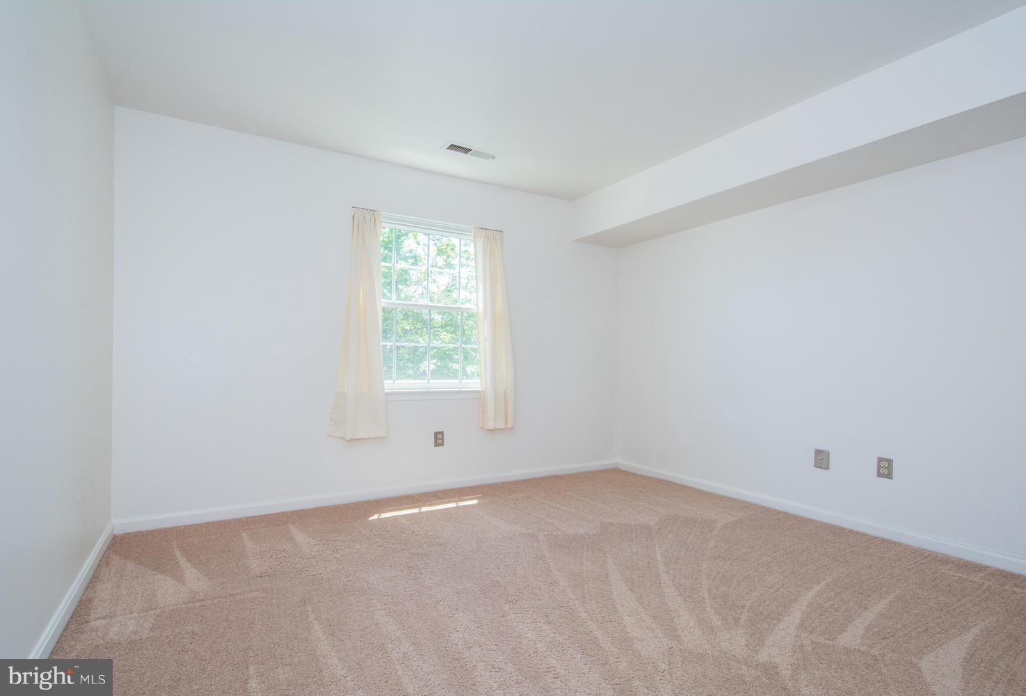 8335 Montgomery Run Road, Unit H Ellicott City, MD 21043 - Photo 16 of 22 an empty room with a window