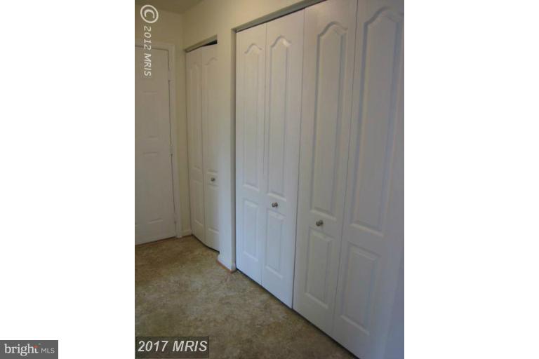 8335 Montgomery Run Road, Unit H Ellicott City, MD 21043 - Photo 9 of 22 a view of a bathroom with a shower curtain