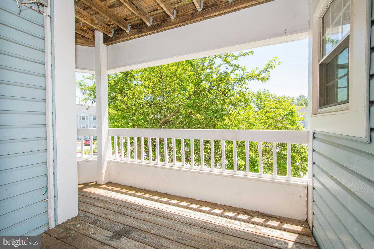 8335 Montgomery Run Road, Unit H Ellicott City, MD 21043 - Photo 10 of 22 a view of porch with wooden floor
