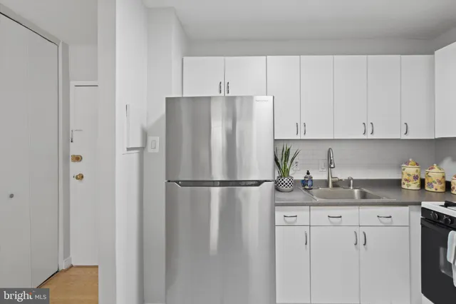 a white refrigerator freezer sitting in a kitchen