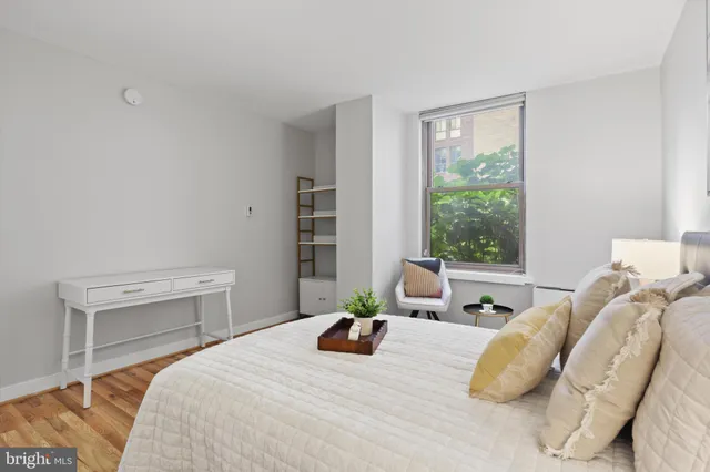 a bedroom with a bed and a potted plant