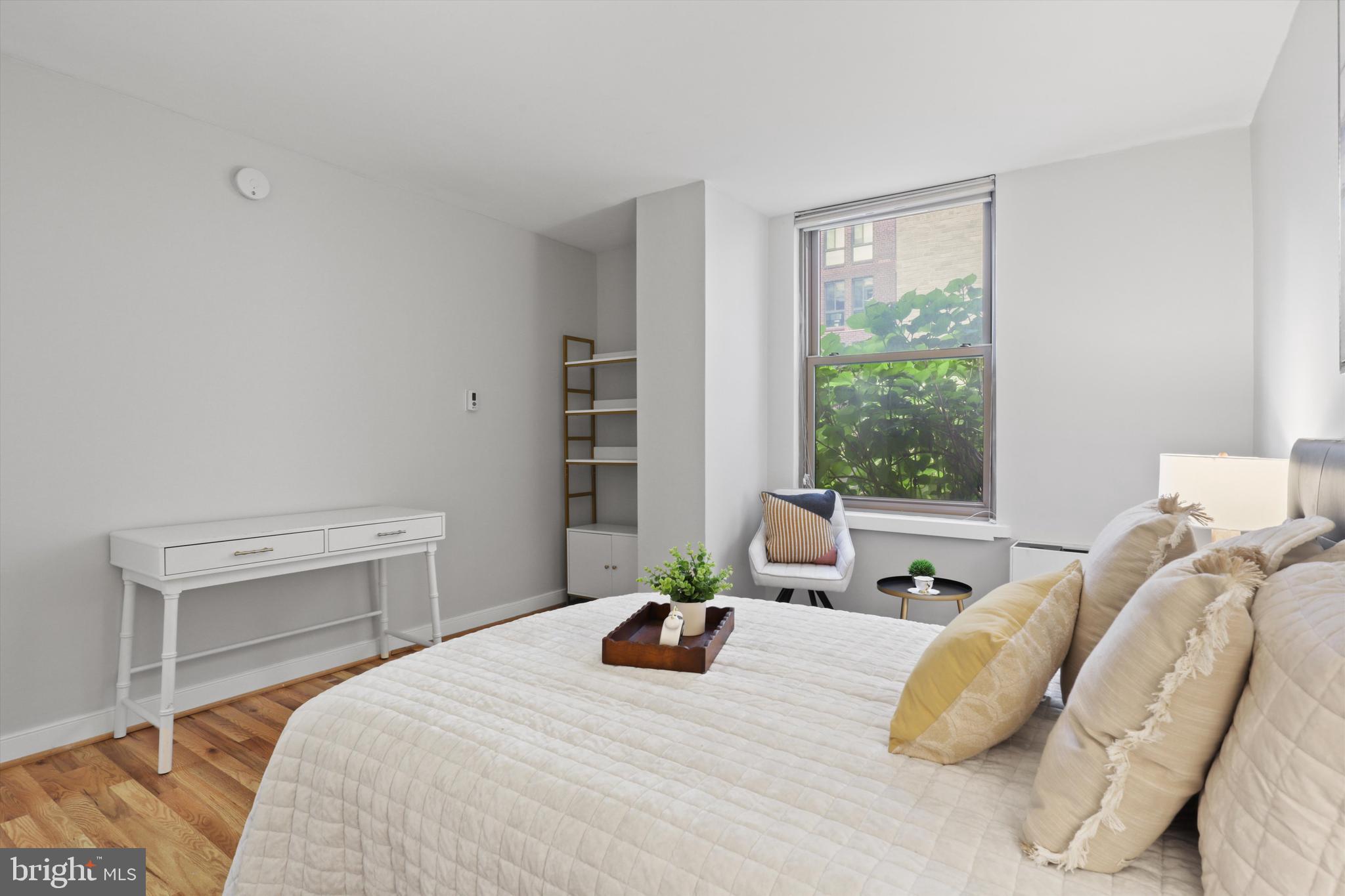1260 21st Street Northwest, Unit 108 Washington, DC 20036 - Photo 15 of 23 a bedroom with a bed and a potted plant