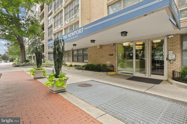 a front view of a building with a garden