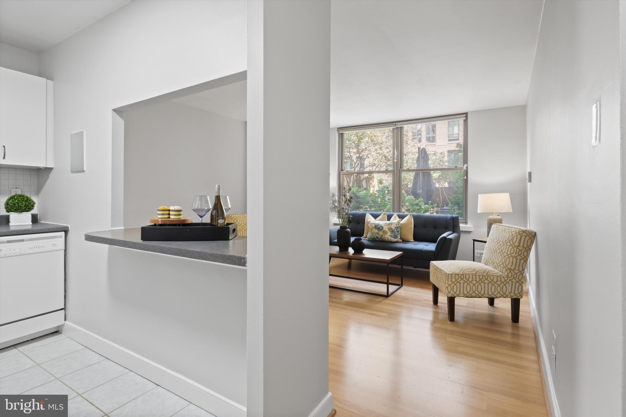 1260 21st Street Northwest, Unit 108 Washington, DC 20036 - Photo 6 of 23 a living room with furniture and a large window