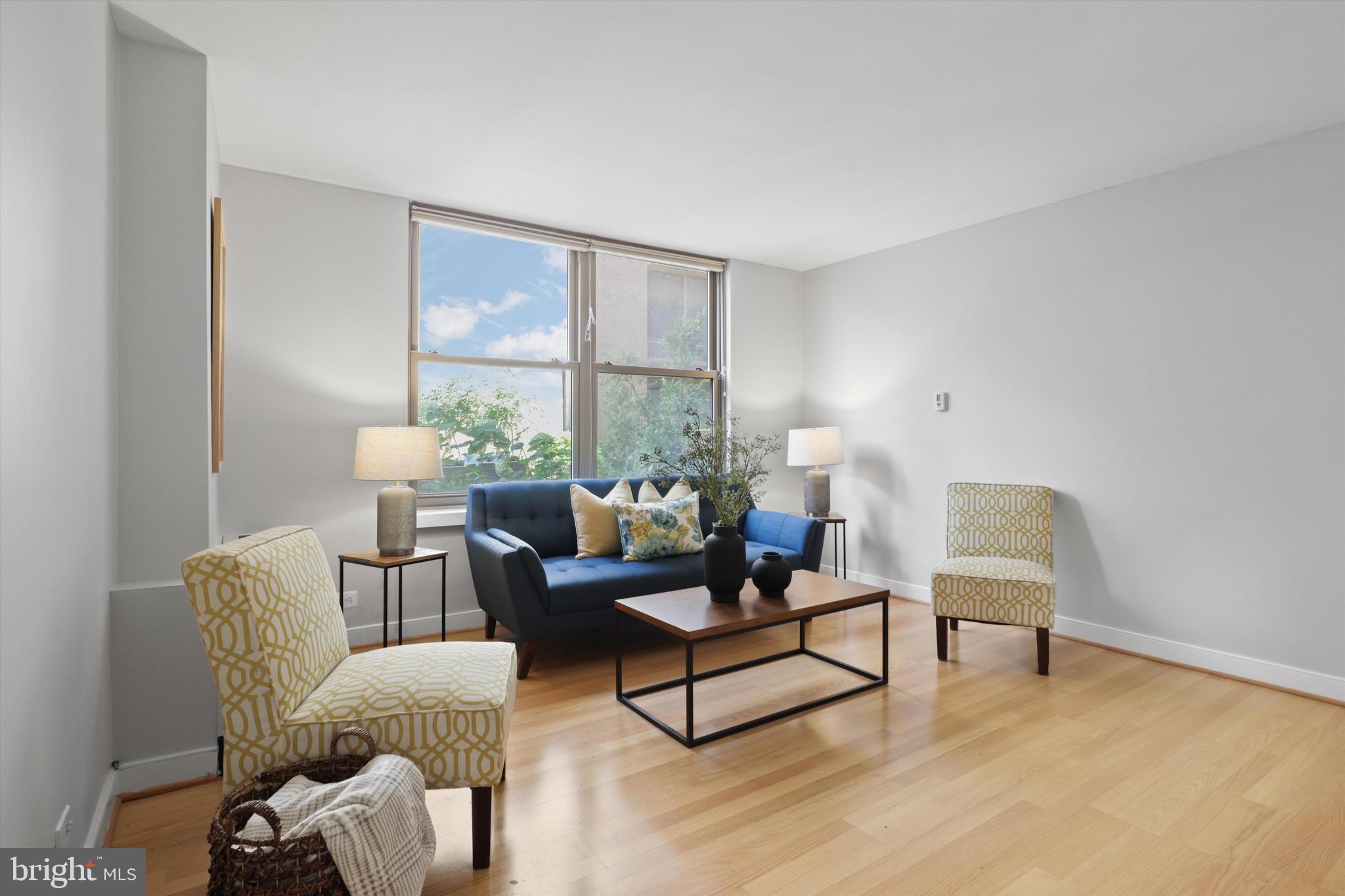 1260 21st Street Northwest, Unit 108 Washington, DC 20036 - Photo 8 of 23 a living room with furniture and a large window