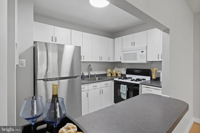 a kitchen with stainless steel appliances a refrigerator sink and cabinets