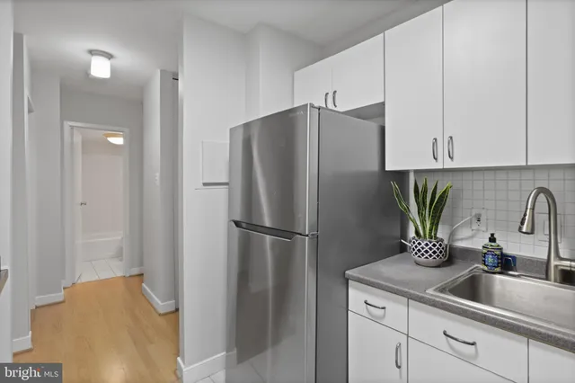 a kitchen with a refrigerator and a sink