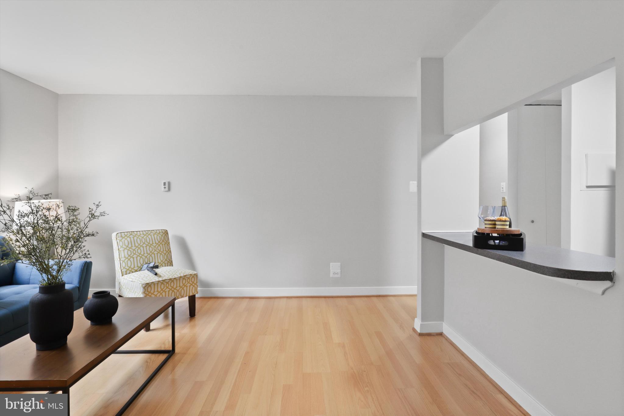 1260 21st Street Northwest, Unit 108 Washington, DC 20036 - Photo 9 of 23 a view of a living room with furniture and wooden floor