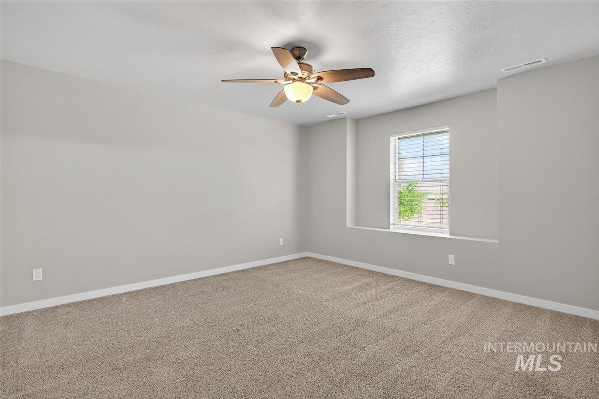 2505 East Goldstone Street Meridian, ID 83642 - Photo 11 of 28 Neutral-toned wall paint and carpeting create a versatile interior