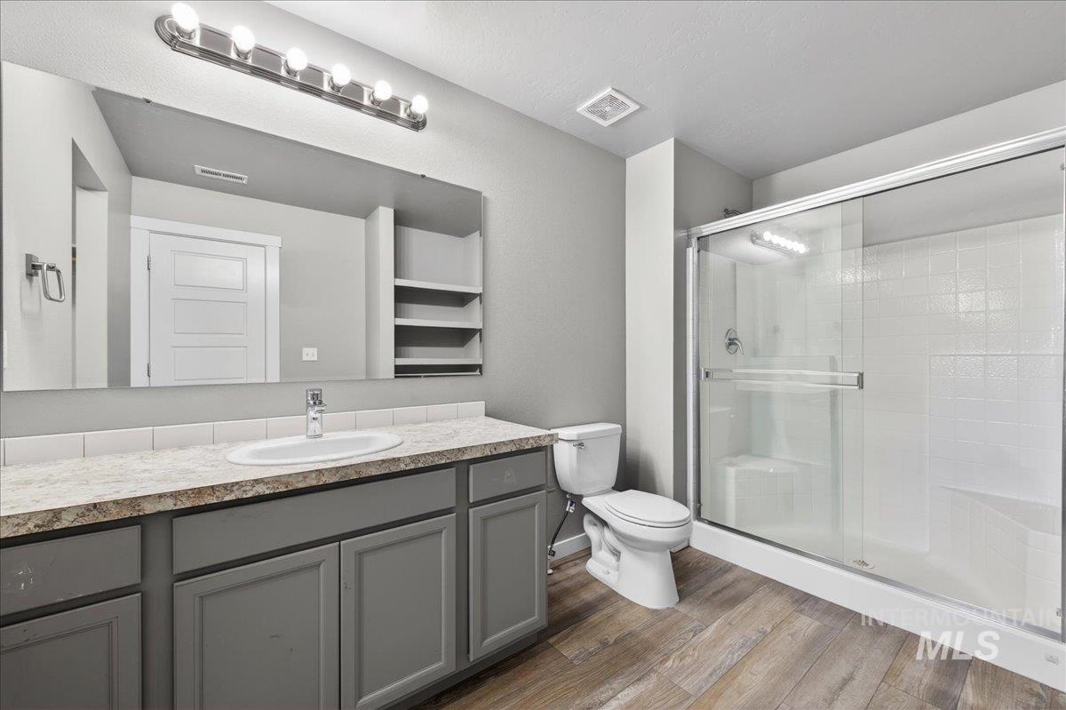 2505 East Goldstone Street Meridian, ID 83642 - Photo 18 of 28 Bathroom featuring a spacious vanity with gray cabinetry, a rectangular undermount sink, and a speckled countertop