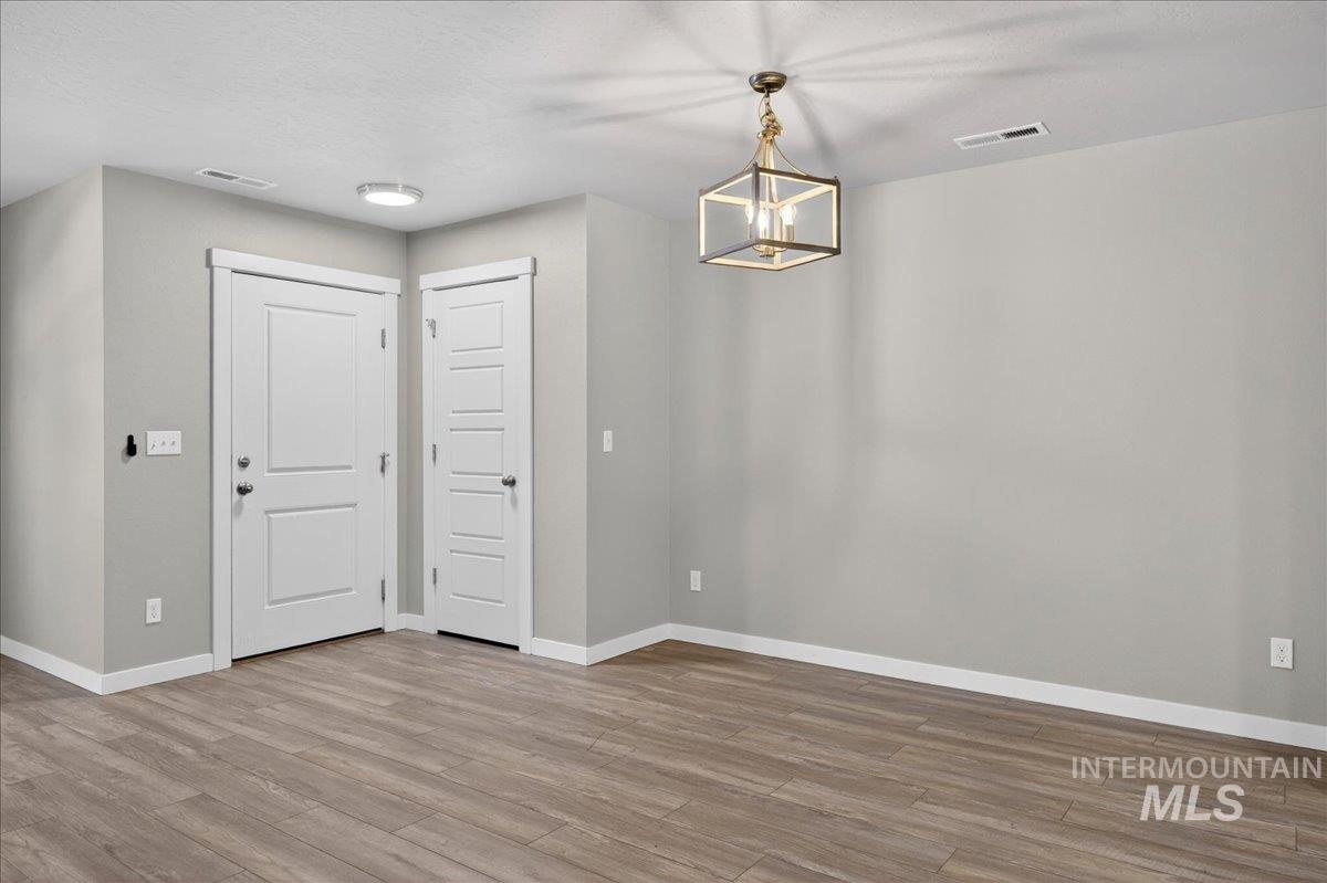 2505 East Goldstone Street Meridian, ID 83642 - Photo 6 of 28 Spacious room with wood-finish flooring and neutral wall tones