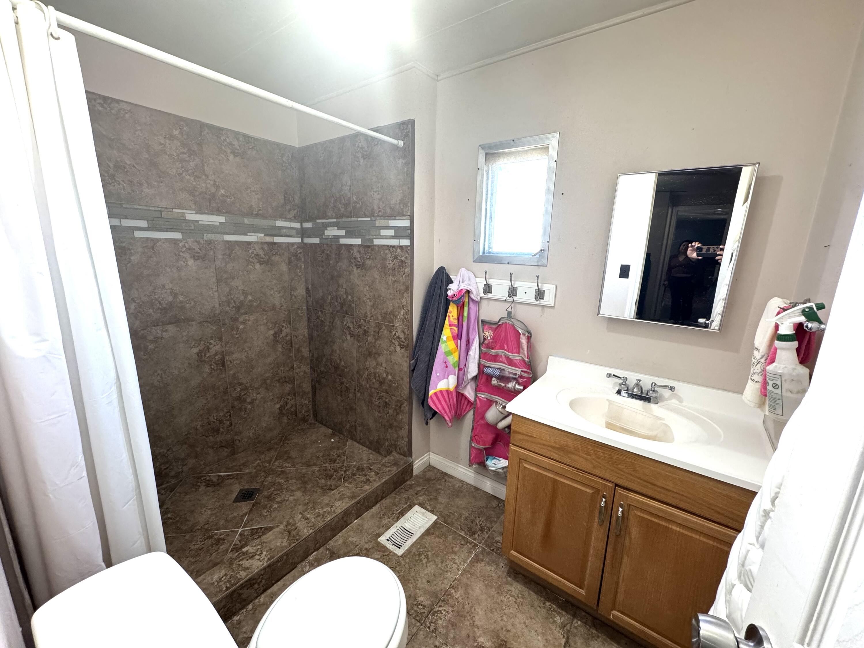 45800 Challanger Way Lancaster, CA 93535 - Photo 9 of 16 a bathroom with a sink toilet and shower
