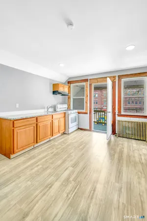a view of a kitchen with a sink and a large window