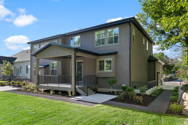 2724 Mt Jordan Road Sandy, UT 84092 - Photo 34 of 39 Rear exterior featuring a covered patio, composite deck, stucco siding, and black metal railings