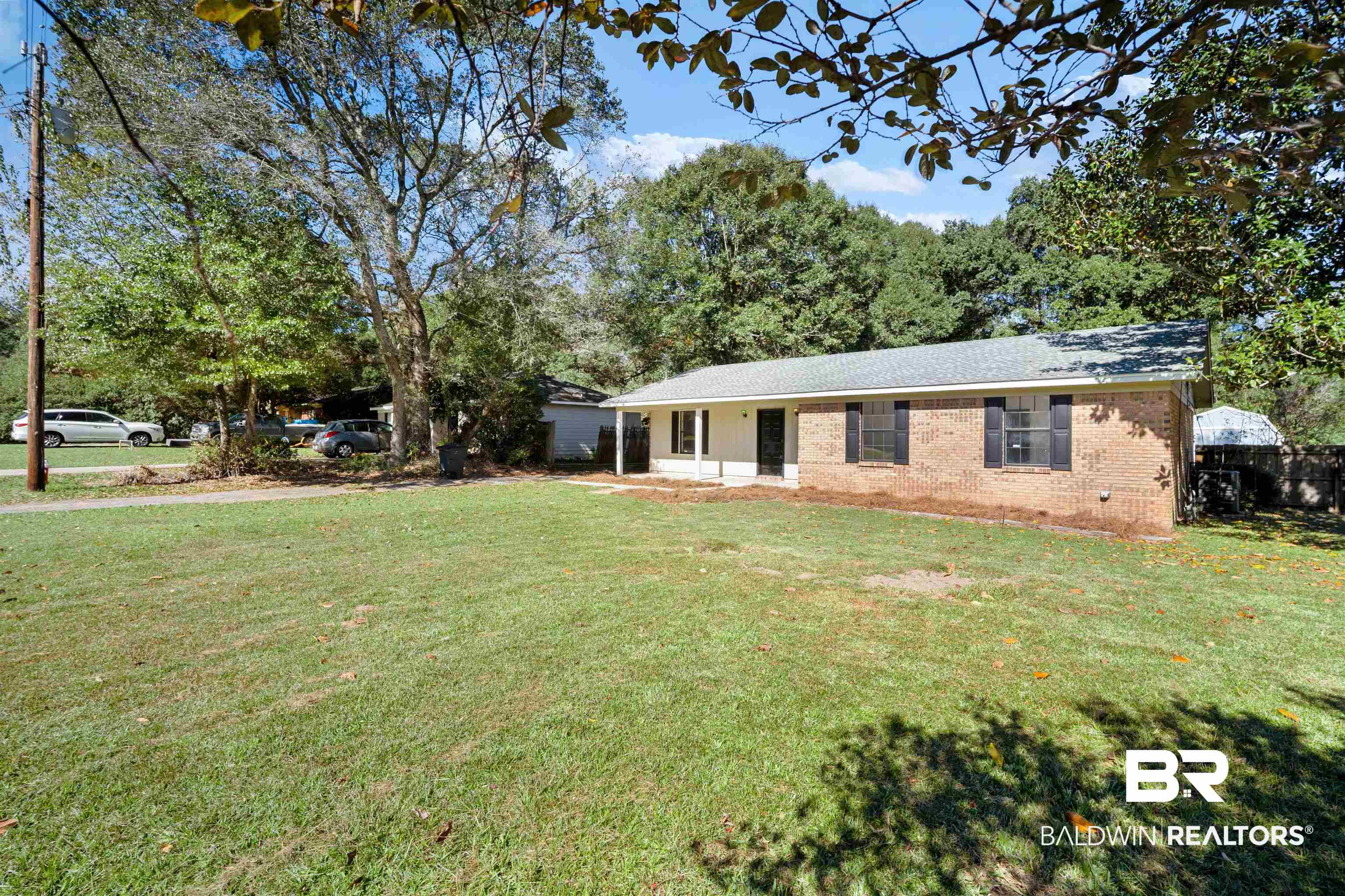 12910 Del Rio Street Grand Bay, AL 36541 - Photo 2 of 26 Single story home with a front lawn, brick siding, and covered porch