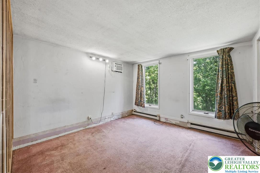 5340 2nd Street Whitehall, PA 18052 - Photo 11 of 30 A well-lit bedroom features plush carpeting and multiple windows.