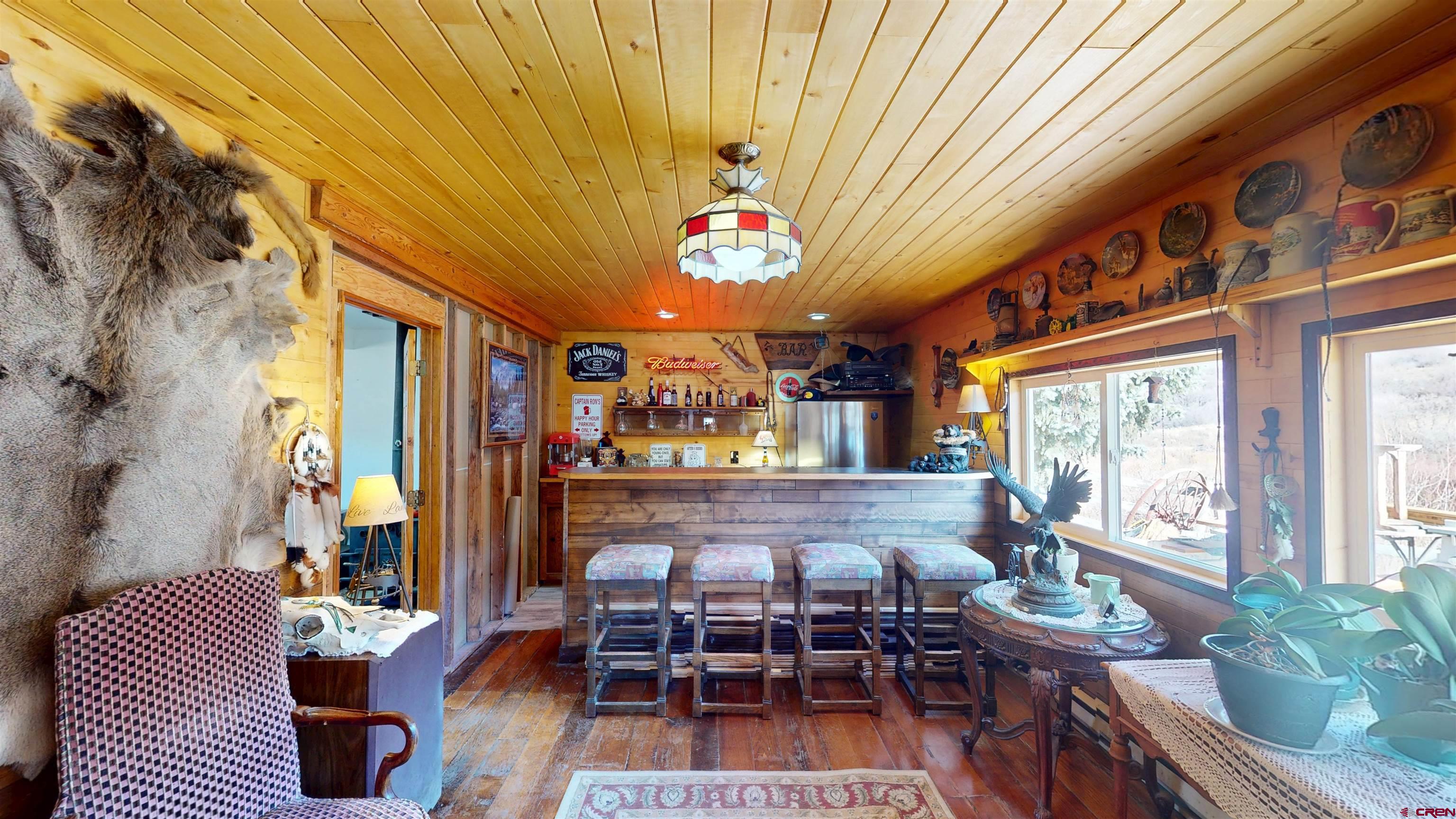 19253 Stevens Gulch Road Paonia, CO 81428 - Photo 11 of 43 a dining room with furniture a rug and a chandelier