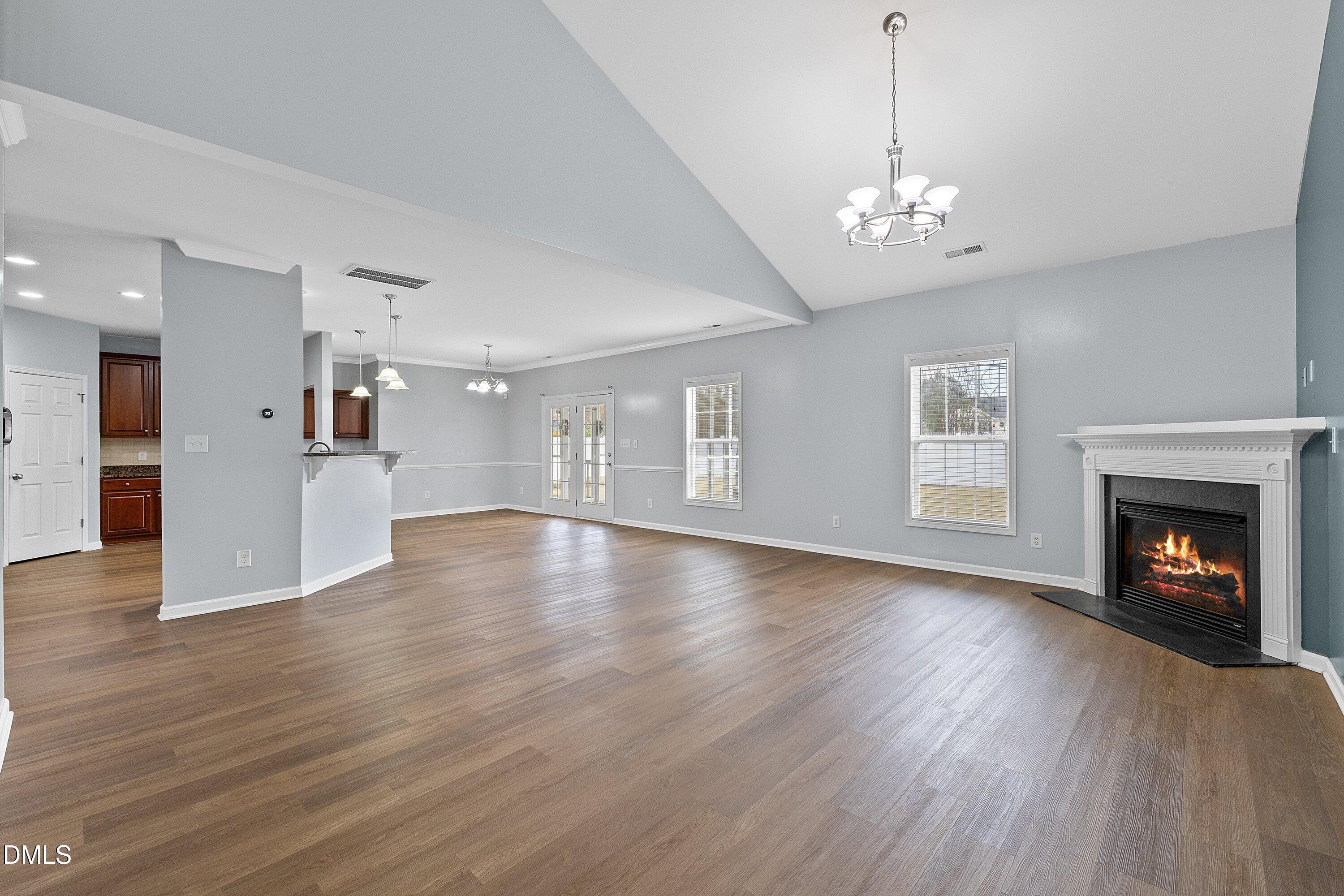 508 Arbor Crest Road Holly Springs, NC 27540 - Photo 13 of 45 a view of a room with wooden floor and fireplace