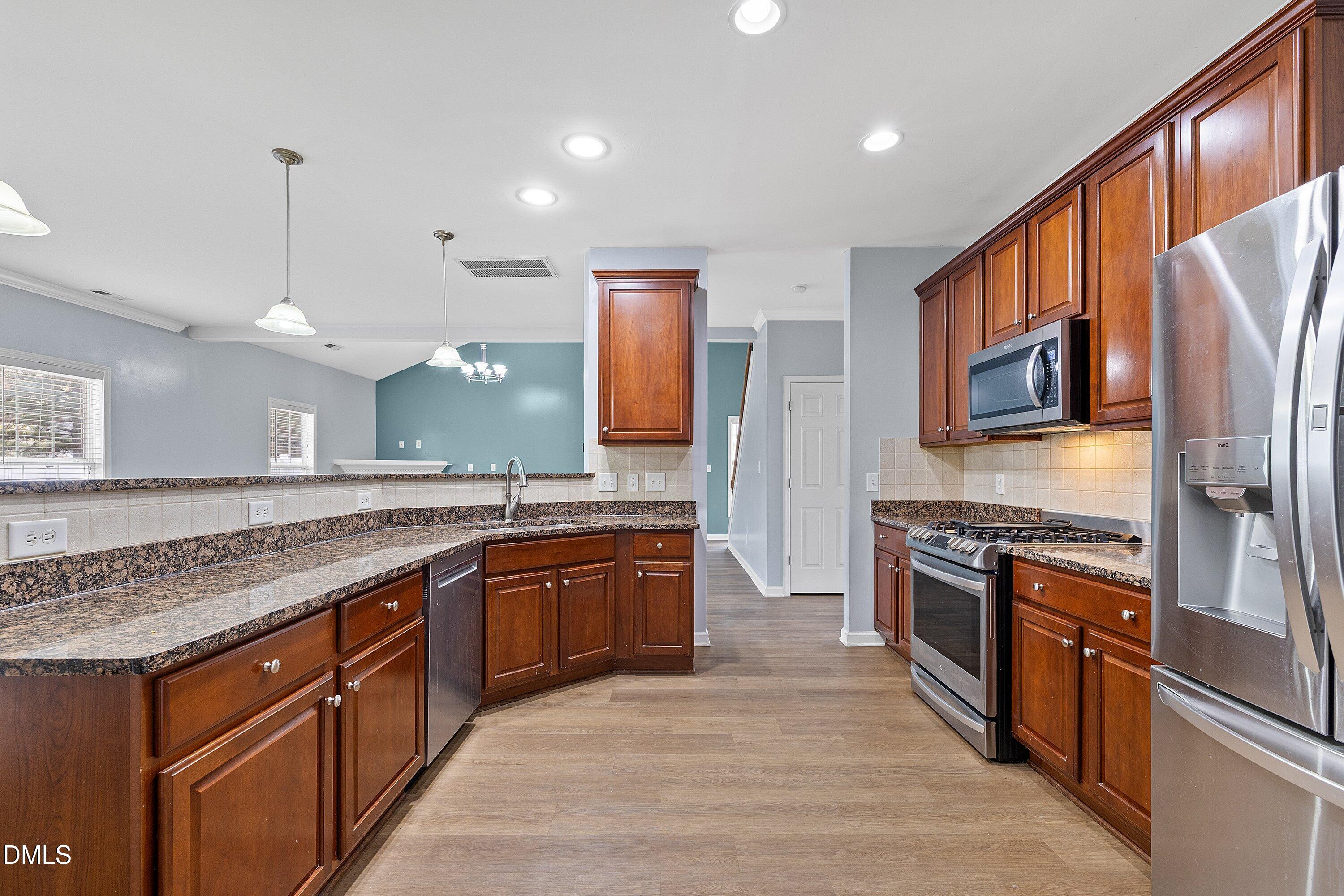 508 Arbor Crest Road Holly Springs, NC 27540 - Photo 17 of 45 a large kitchen with stainless steel appliances granite countertop a stove a sink dishwasher a refrigerator and a oven