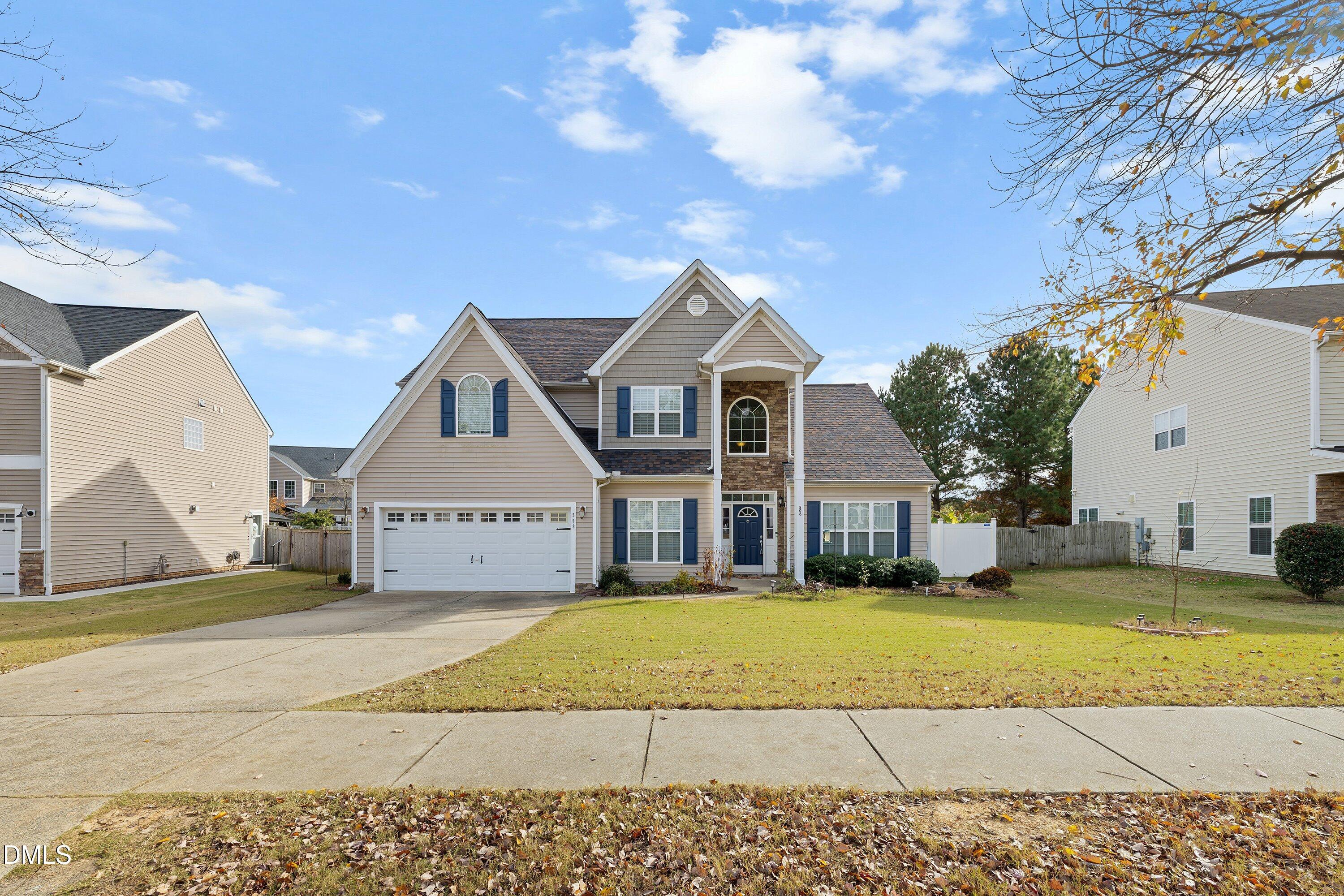 508 Arbor Crest Road Holly Springs, NC 27540 - Photo 2 of 45 a view of a big house with a big yard and large trees