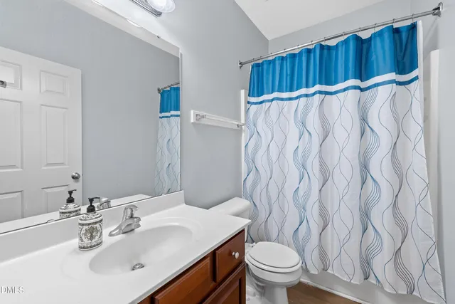 a bathroom with a sink toilet and a mirror